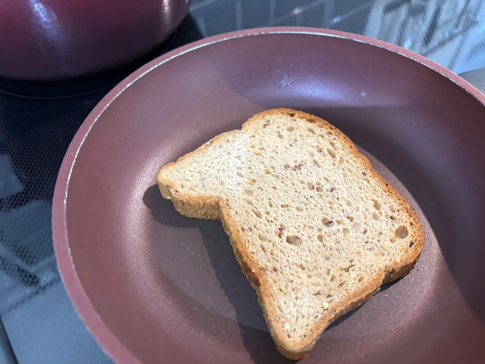 bottom slice of gluten free buttered bread in pan