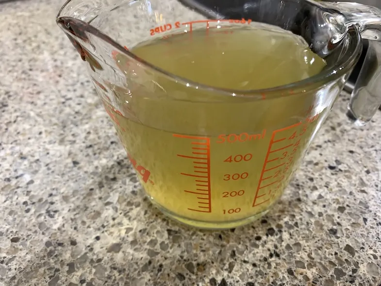 Two cups of broth in a measuring cup