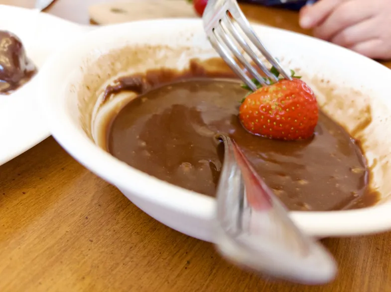dipping strawberry in chocolate