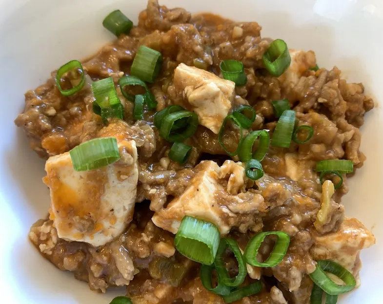 gluten-free mabo dofu with green onion garnish