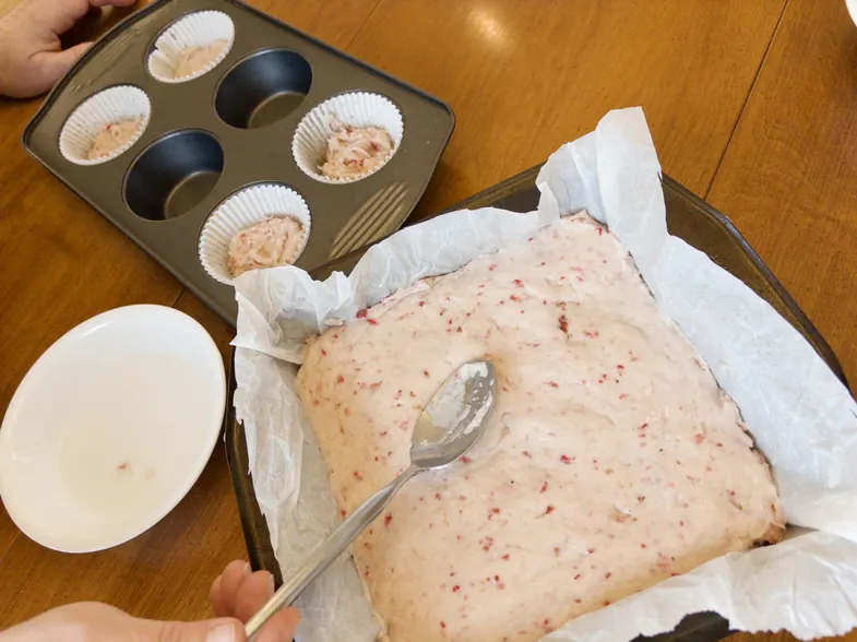 smoothing batter out with back of a spoon