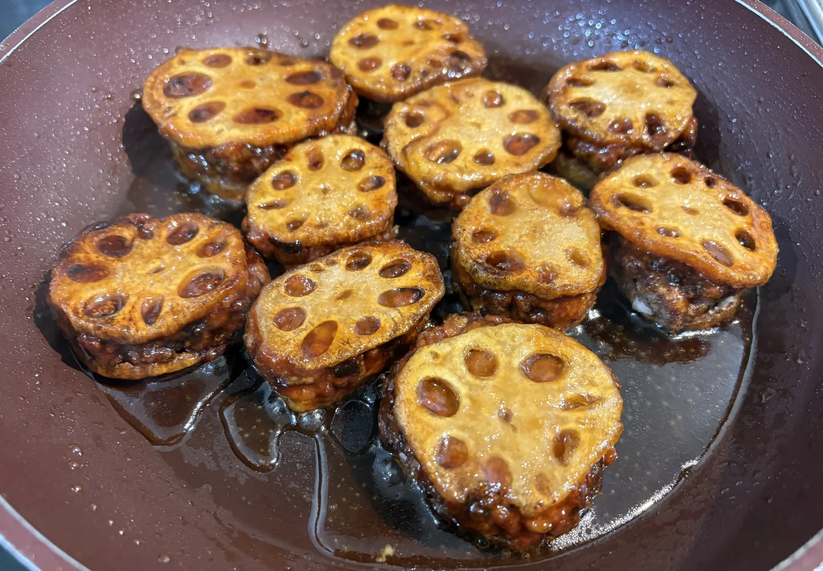 stuffed renkon in frying pan with sauce